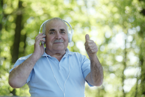 Happy senior man listening to music